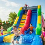 Colorful inflatable water slide at a sunny party with children enjoying