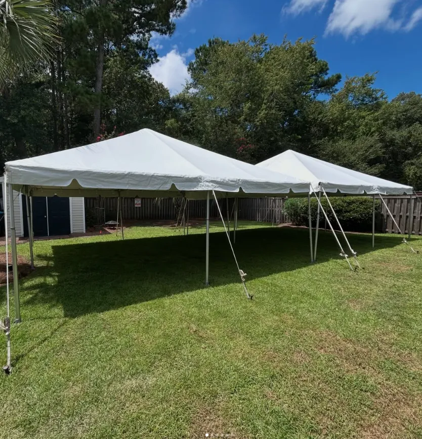 Large white tents set up on a green lawn, showcasing Palm Tree Party Rentals’ corporate